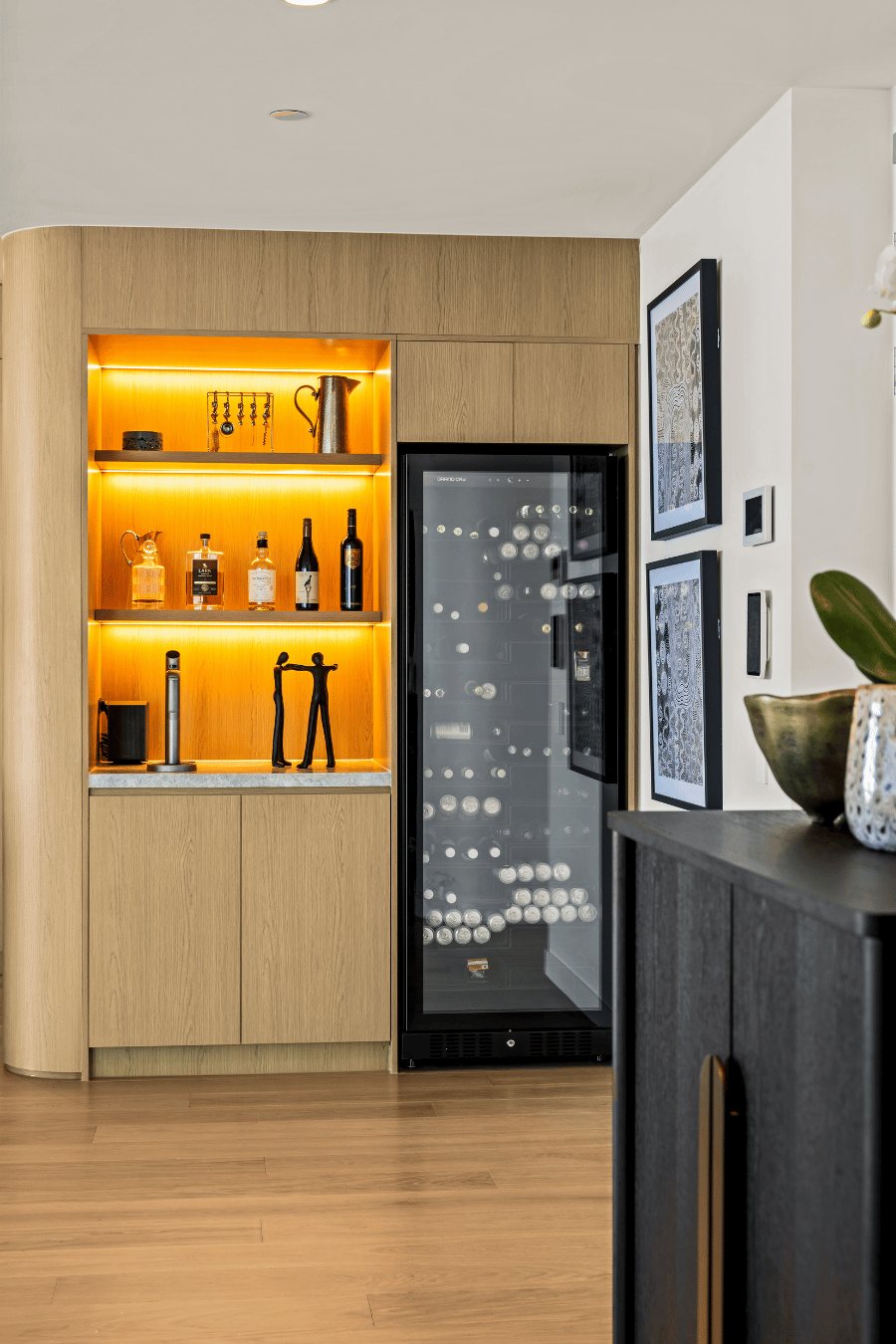 Built-in bar nook with backlit shelving, glassware and an integrated wine fridge — Oceanside